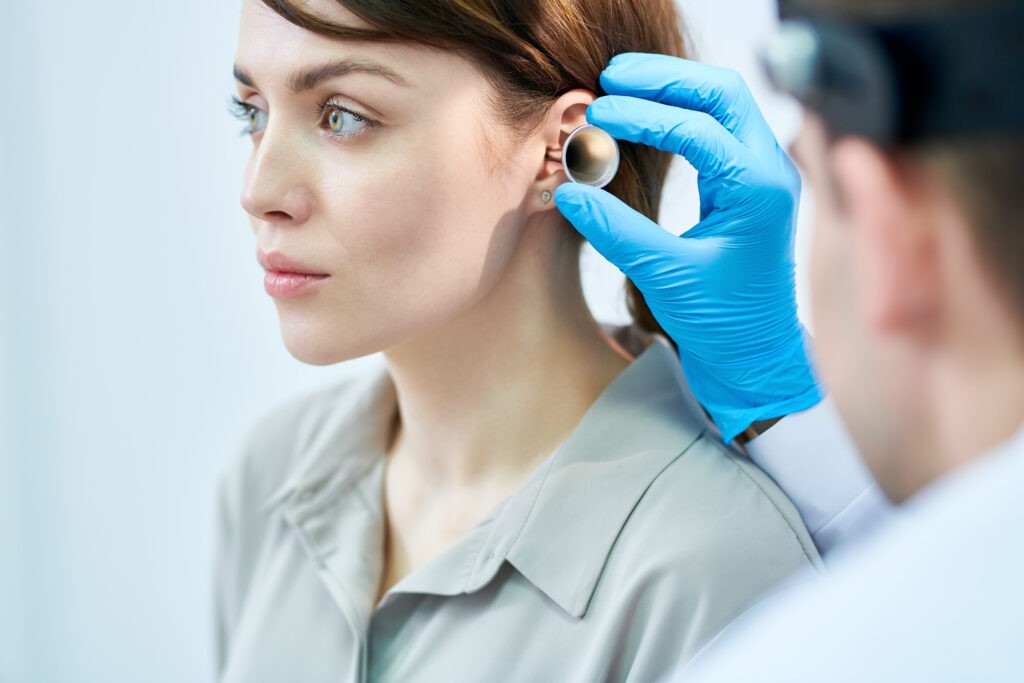 audiologist examining ears 2021 09 24 04 02 49 utc scaled